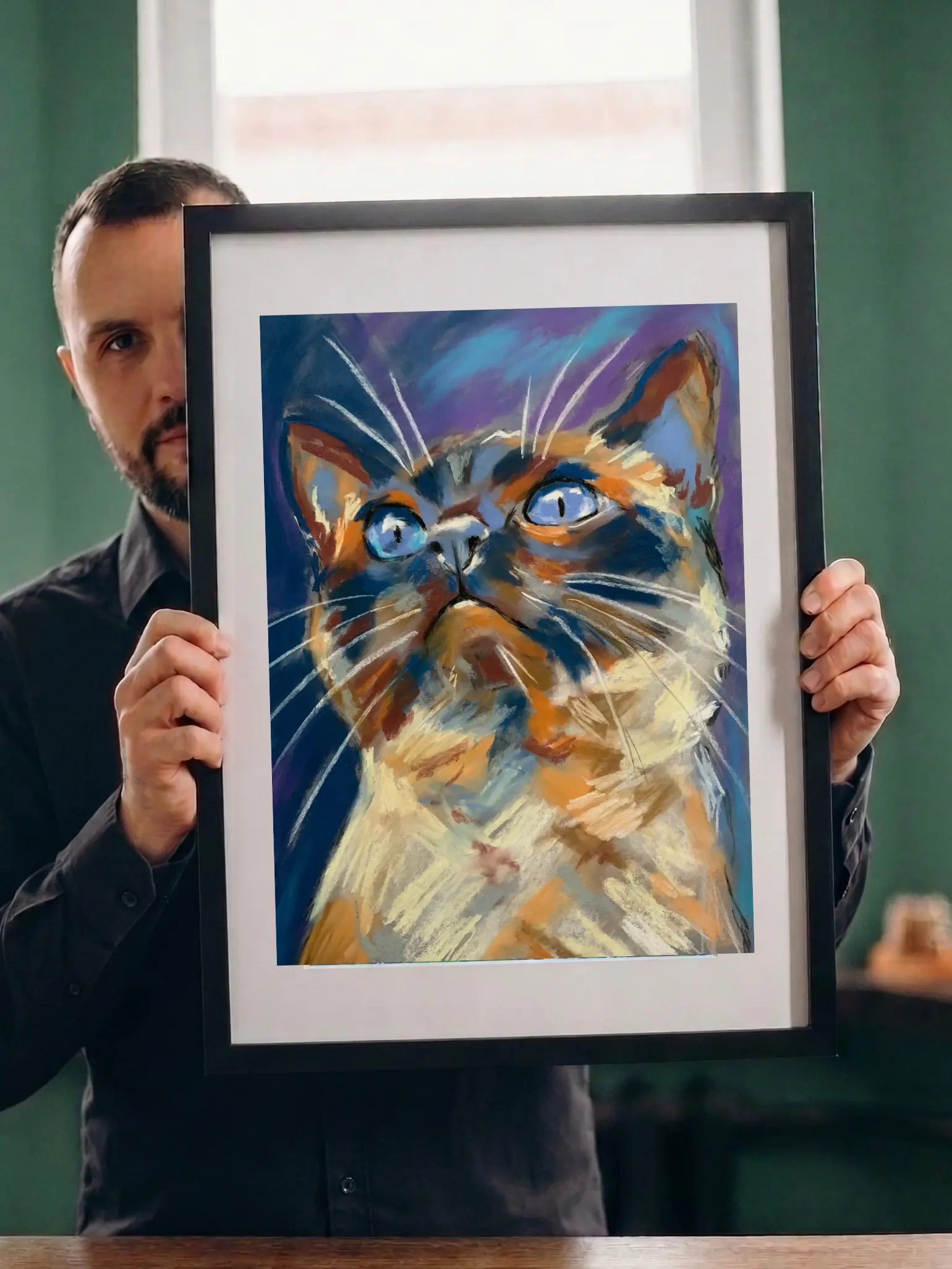 Artist holding framed expressionist soft pastel blue-eyed cat portrait painting